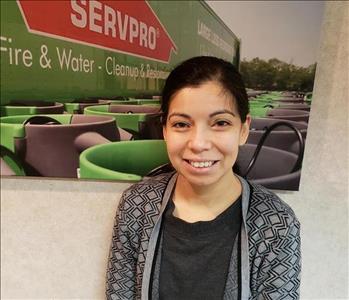 picture of Keren standing in front of SERVPRO banner