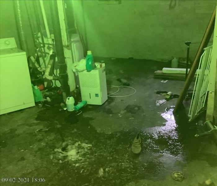 picture of a basement with water puddles on the floor