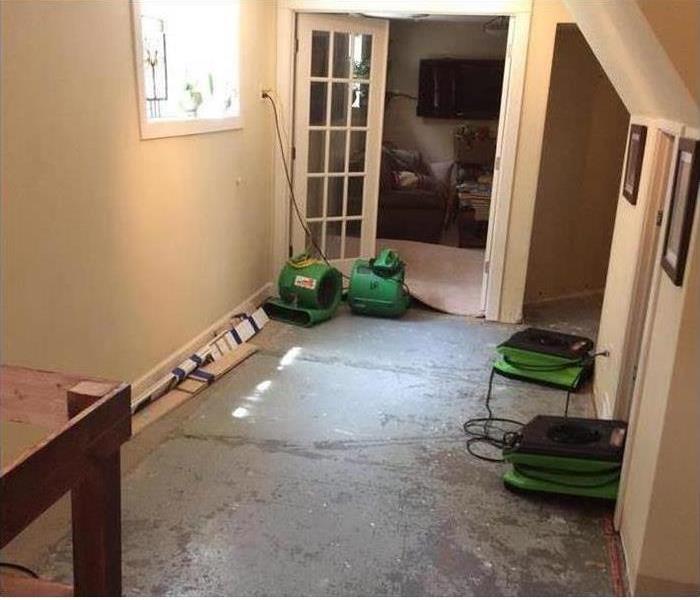 picture of a room with several SERVPRO floor fans drying the area