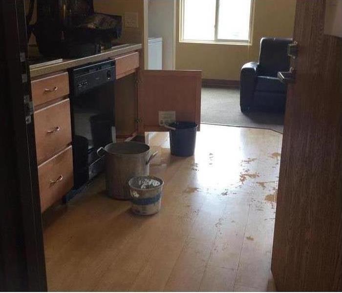 picture of an apartment floor with puddles of water on it
