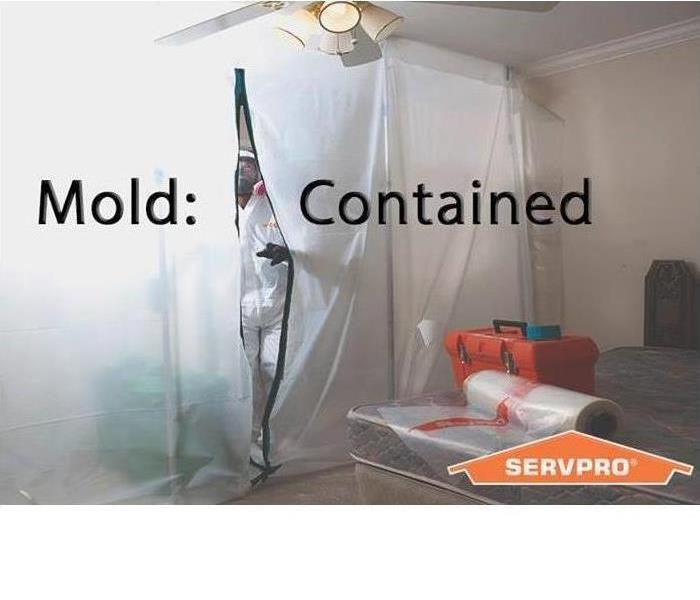 Picture of a containment barrier with the words "mold contained" across the middle of picture and SERVPRO logo on bottom