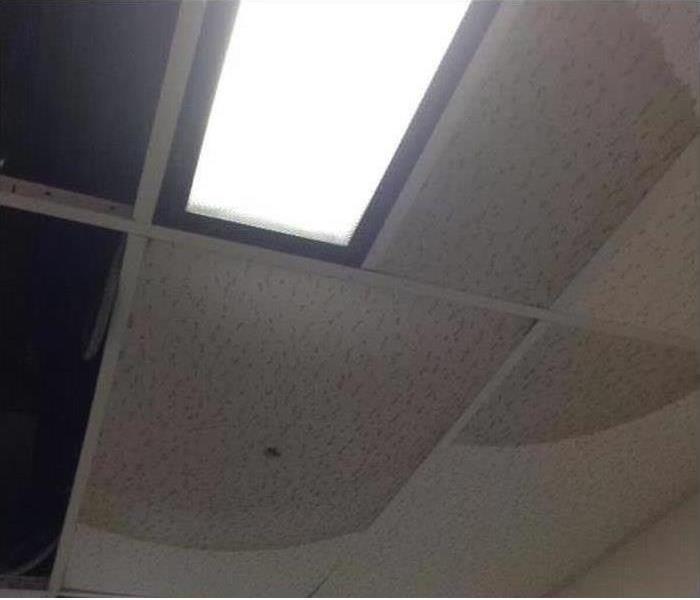 Picture of a ceiling where the tiles are water stained