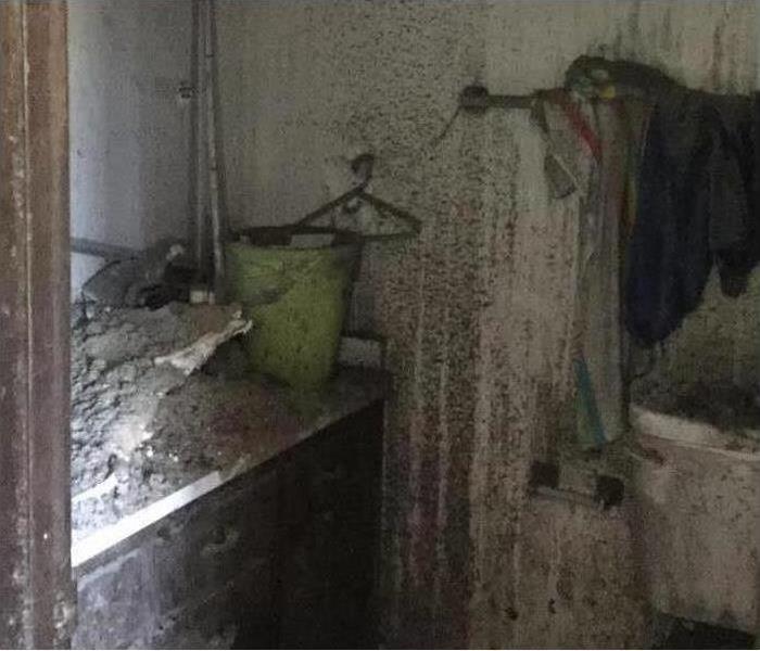picture of a bathroom covered in black soot from a fire