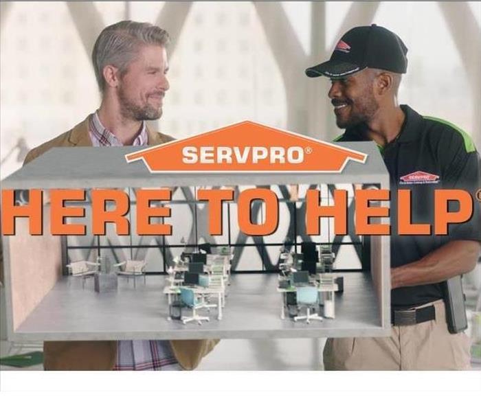 Picture of a servpro employee shaking hands with a customer with the words "Here to Help" written across the picture