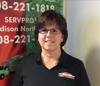 picture of Jackie Scheiwe standing in front of the Servpro banner