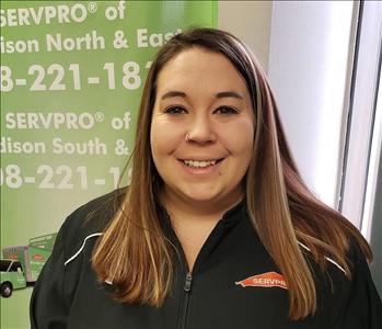 picture of Candice standing in front of a SERVPRO banner